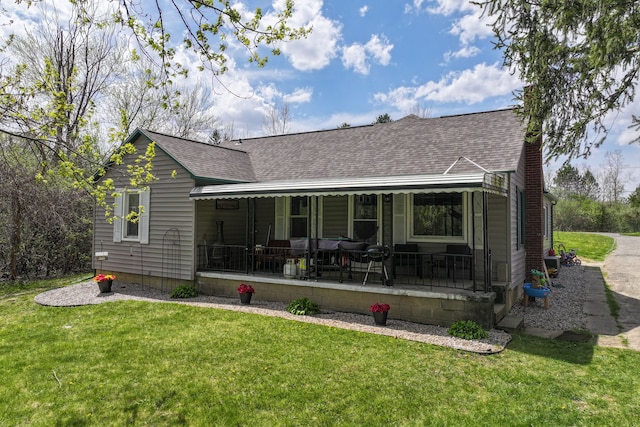 8119 N Dort Hwy, Mount Morris, MI 48458 - rear view of house with a porch, a lawn, and roof with shingles