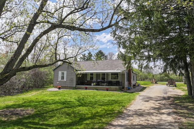 8119 N Dort Hwy, Mount Morris, MI 48458 - bungalow-style home with a porch, a front lawn, and driveway