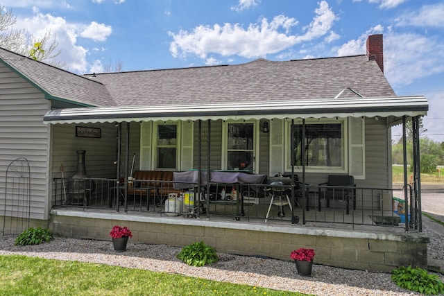 8119 N Dort Hwy, Mount Morris, MI 48458 - back of property featuring a porch, a shingled roof, and a chimney