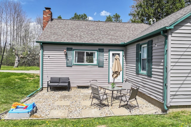 8119 N Dort Hwy, Mount Morris, MI 48458 - rear view of property with a shingled roof, a patio area, a yard, and a chimney