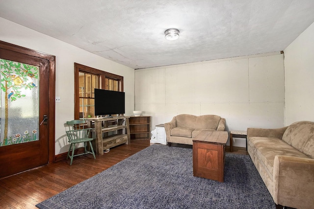 living area featuring baseboards and wood finished floors