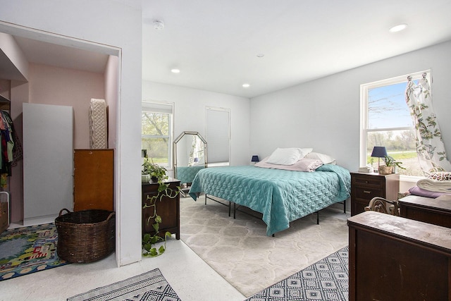 bedroom with multiple windows and recessed lighting