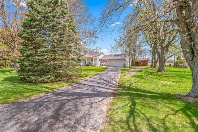 8531 S Waldron Rd, Pittsford, MI 49271 - view of front of property featuring an attached garage, driveway, and a front yard