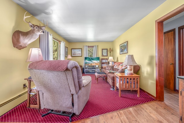 8531 S Waldron Rd, Pittsford, MI 49271 - living area featuring baseboards, baseboard heating, and wood finished floors