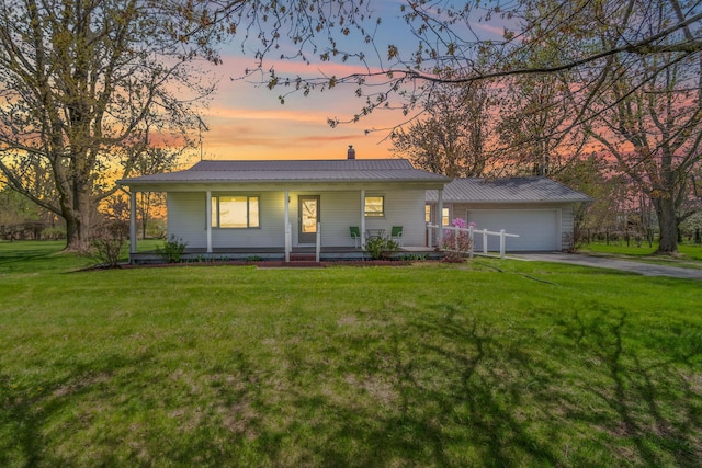8531 S Waldron Rd, Pittsford, MI 49271 - ranch-style home with covered porch, driveway, metal roof, a lawn, and an attached garage
