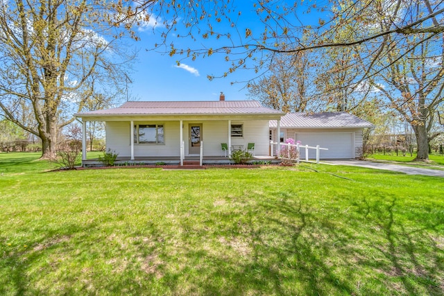 8531 S Waldron Rd, Pittsford, MI 49271 - view of front of home featuring a porch, driveway, metal roof, a garage, and a front lawn