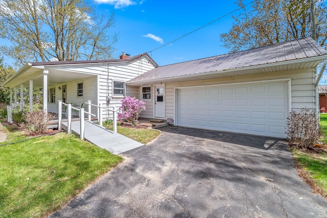 8531 S Waldron Rd, Pittsford, MI 49271 - view of front of property with a chimney, metal roof, a front lawn, and aphalt driveway