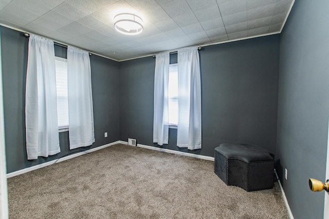 carpeted empty room with baseboards