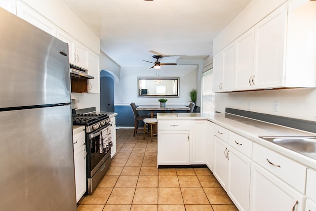 kitchen featuring under cabinet range hood, a ceiling fan, white cabinets, and appliances with stainless steel finishes