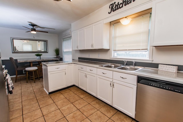kitchen featuring light tile patterned flooring, a sink, dishwasher, a ceiling fan, and white cabinetry