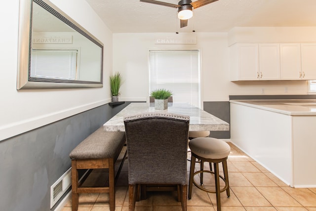 dining room featuring light tile patterned floors, a ceiling fan, and visible vents