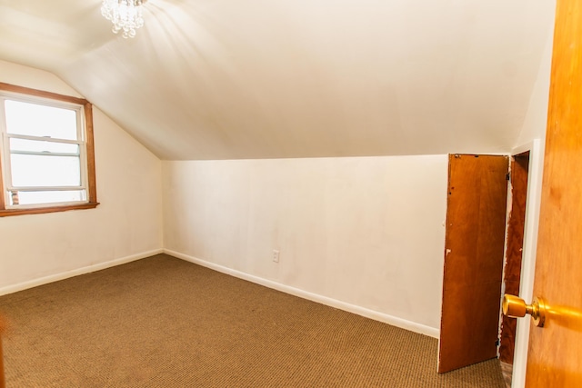 bonus room featuring baseboards, vaulted ceiling, and carpet