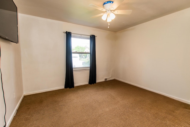 empty room featuring carpet floors, baseboards, ceiling fan, and visible vents