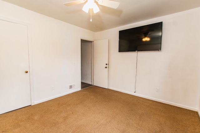 unfurnished bedroom featuring visible vents, carpet flooring, baseboards, and a ceiling fan