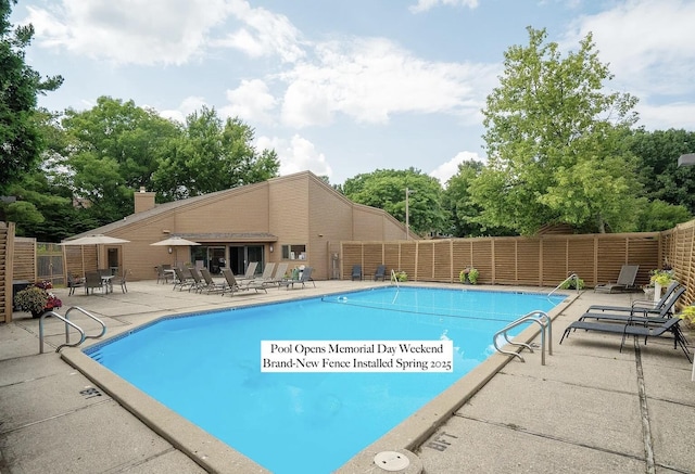 community pool featuring a patio and fence