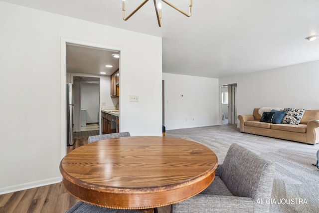 living area with baseboards and light wood-type flooring