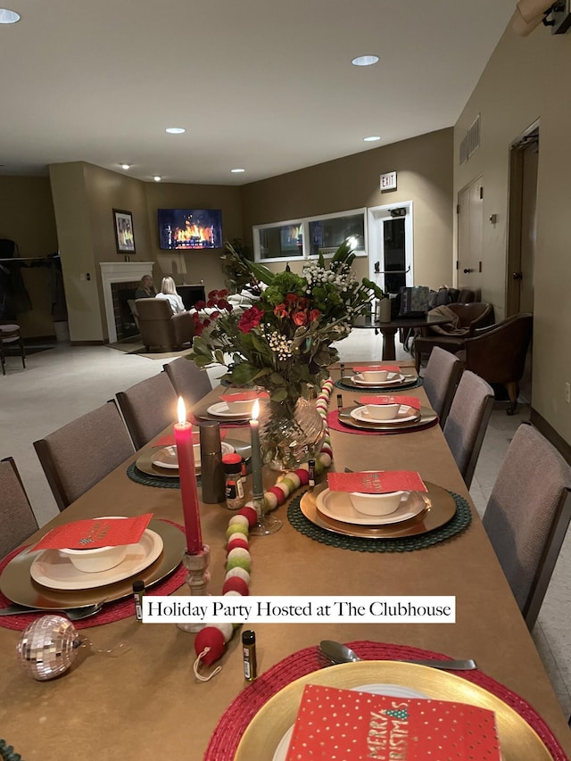 dining room with carpet flooring, recessed lighting, visible vents, and a fireplace
