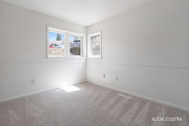 empty room with carpet flooring and baseboards