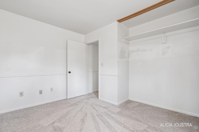 unfurnished bedroom with baseboards and carpet