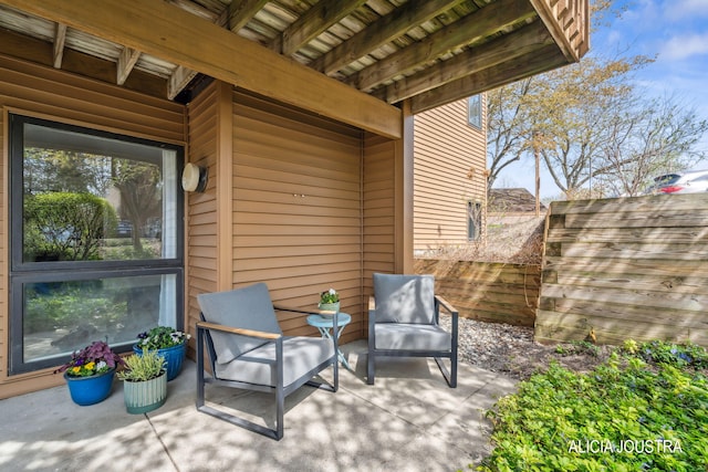 view of patio featuring fence