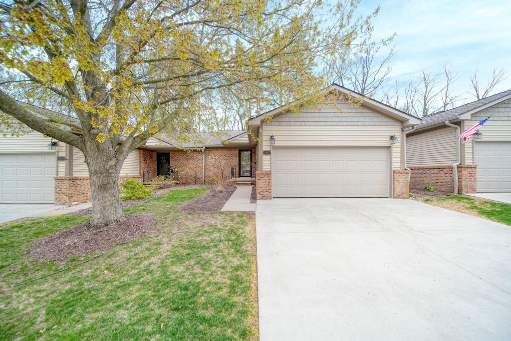 ranch-style house with an attached garage, driveway, and brick siding