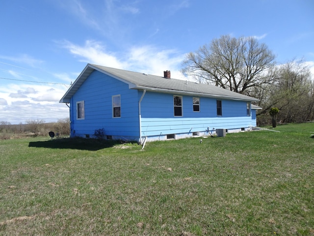 view of home's exterior with a lawn and a chimney