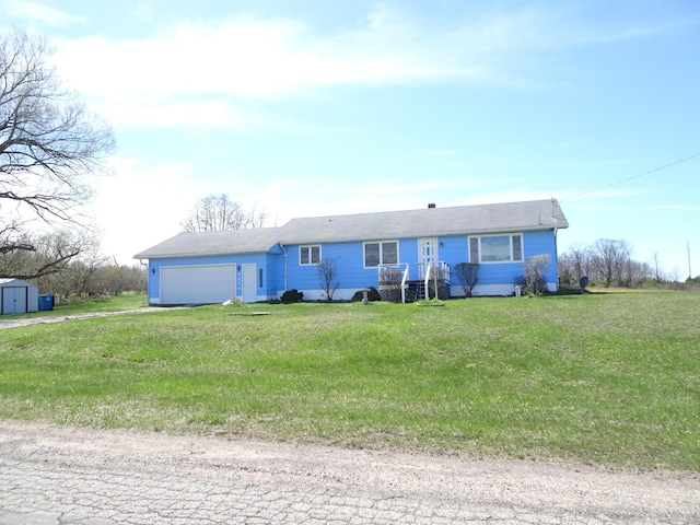 single story home with an attached garage, a storage unit, a front lawn, and dirt driveway