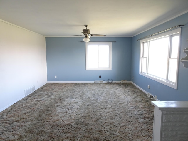 unfurnished room featuring a ceiling fan, baseboards, visible vents, and ornamental molding