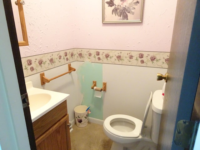 bathroom featuring toilet and vanity