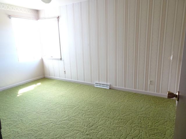 unfurnished room with baseboards, light colored carpet, and visible vents