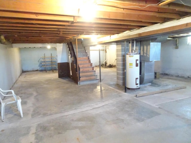 unfinished basement with stairs and water heater