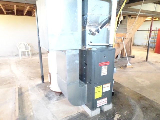 utility room featuring heating unit