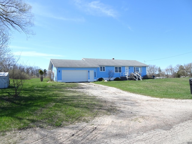 ranch-style house with a garage, driveway, and a front yard