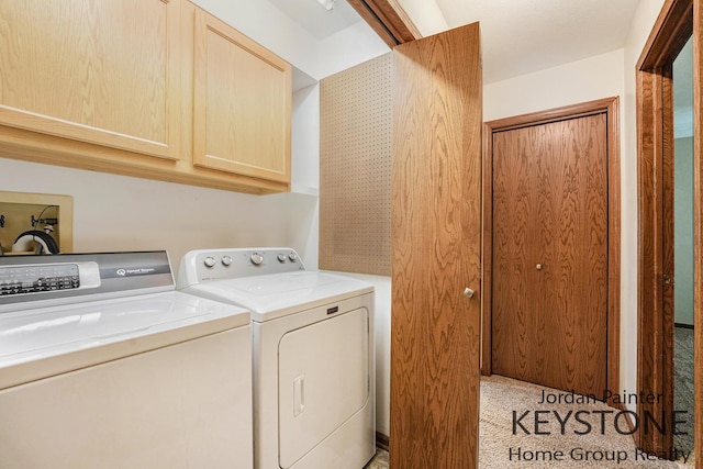 laundry area with light colored carpet, cabinet space, and independent washer and dryer