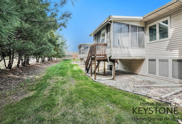view of yard with stairway, cooling unit, and a sunroom