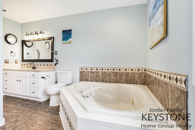 bathroom with vanity, a garden tub, and toilet