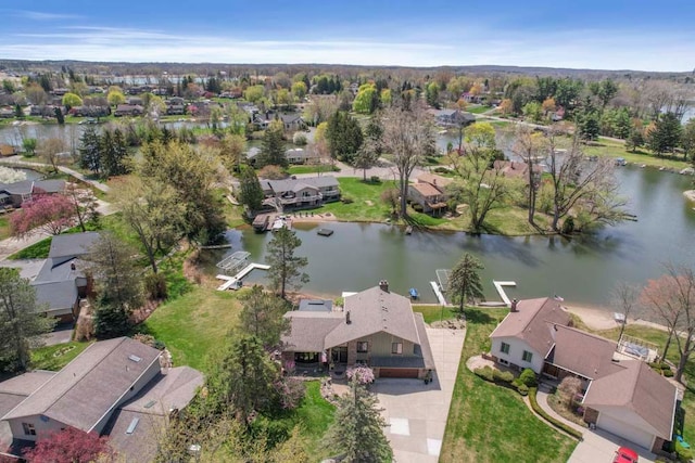 drone / aerial view with a residential view and a water view