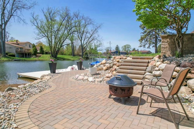 view of patio featuring a water view and an outdoor fire pit
