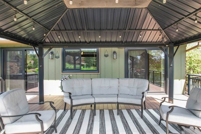 sunroom with track lighting and an outdoor hangout area