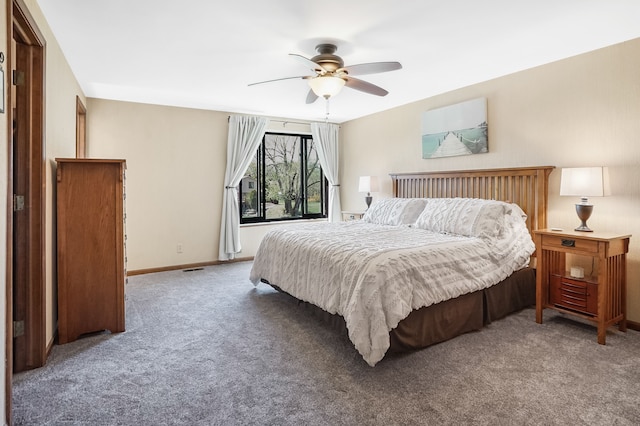 carpeted bedroom with baseboards and ceiling fan