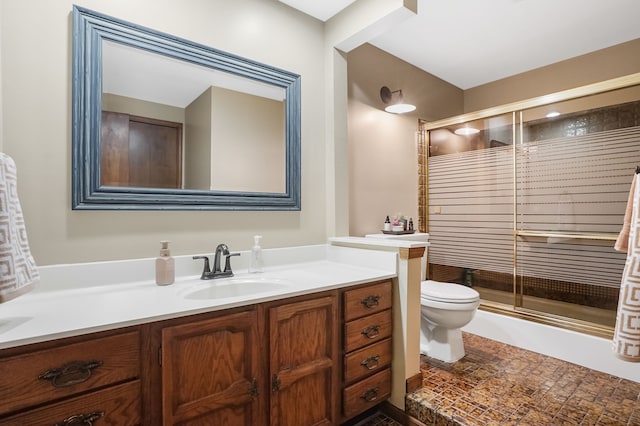bathroom with vanity, a shower stall, and toilet