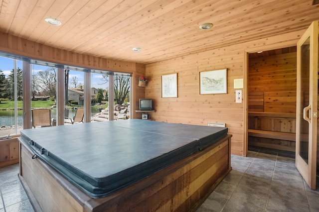 interior space with wooden walls, a water view, recessed lighting, and wooden ceiling