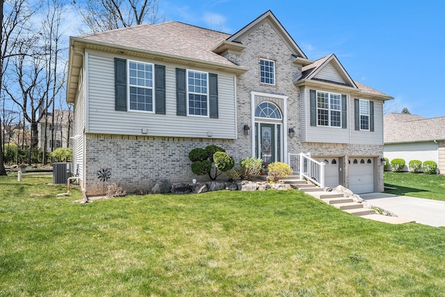 split foyer home with a front lawn, cooling unit, brick siding, concrete driveway, and an attached garage