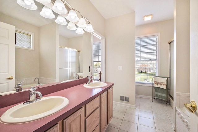 full bathroom featuring double vanity, visible vents, a sink, and a stall shower