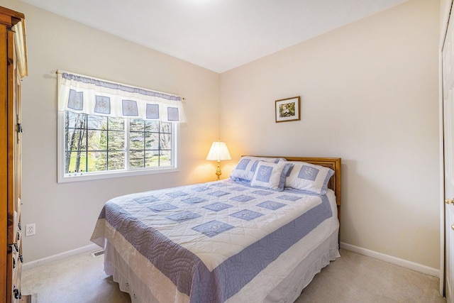 bedroom with carpet floors and baseboards
