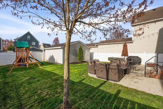 view of yard featuring an outdoor structure, a patio, a fenced backyard, and a playground