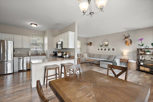 dining room with a healthy amount of sunlight and wood finished floors