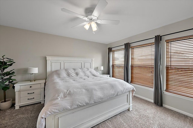 bedroom featuring baseboards, ceiling fan, and light colored carpet