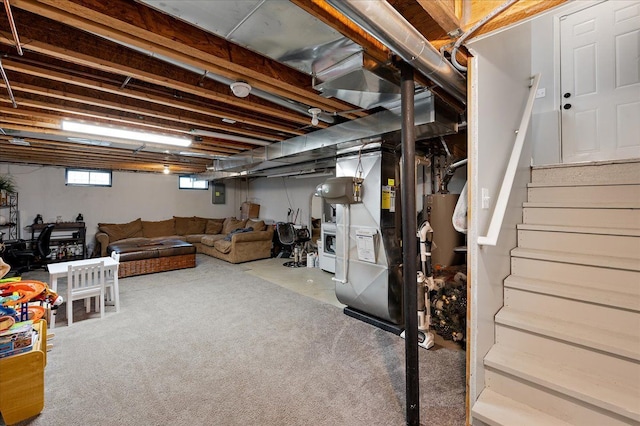 below grade area featuring stairway, carpet floors, heating unit, and gas water heater
