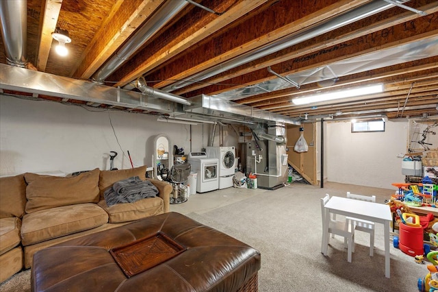 below grade area featuring heating unit and washing machine and dryer